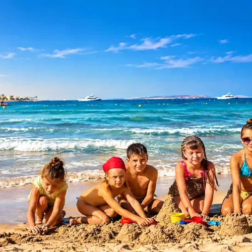 Children Building Sandcastles by the Sea